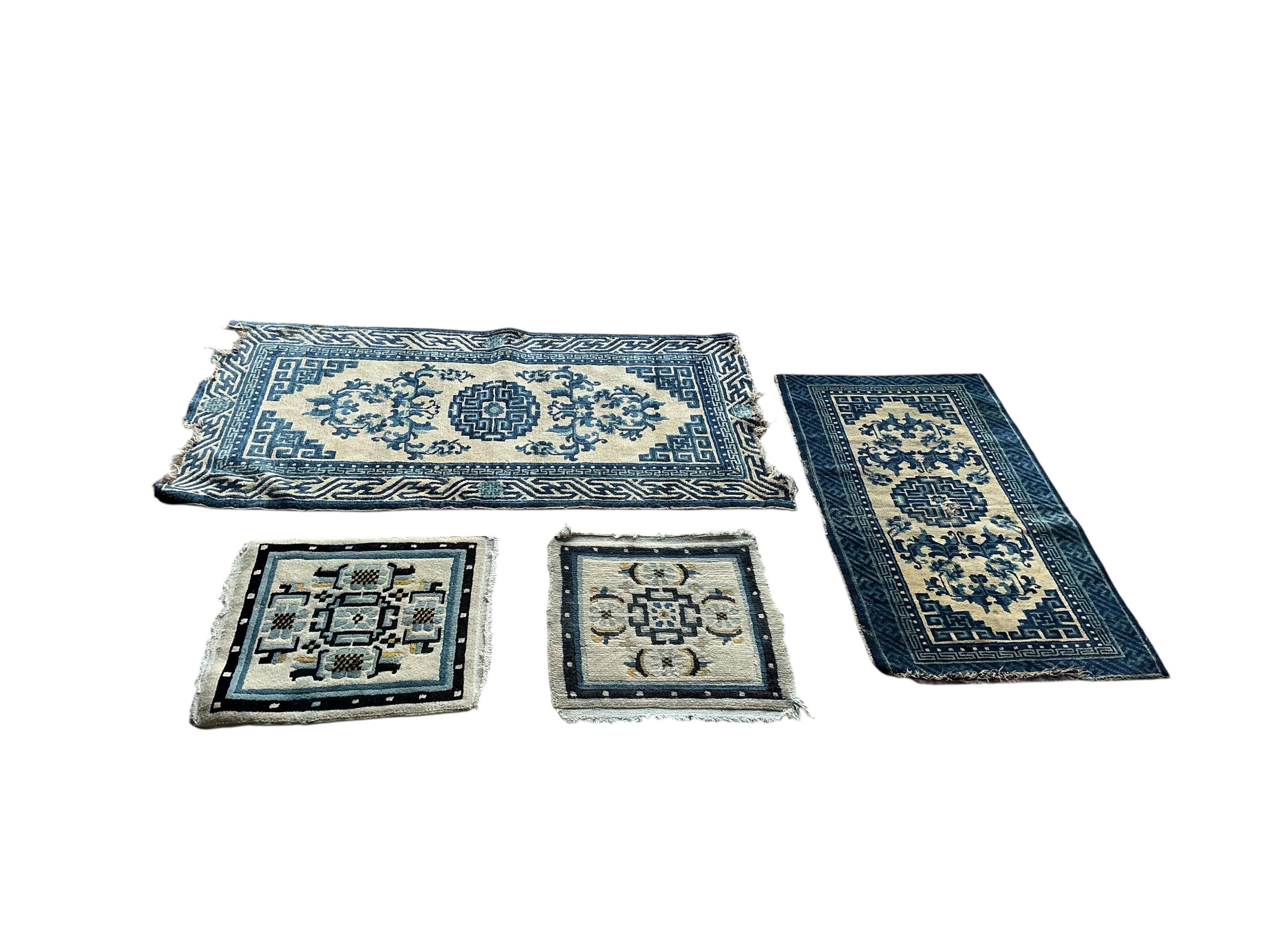 Two Sino-Tibetan ivory ground rugs, 19th century and two Tibetan ivory ground square mats, largest 120 x 66cm